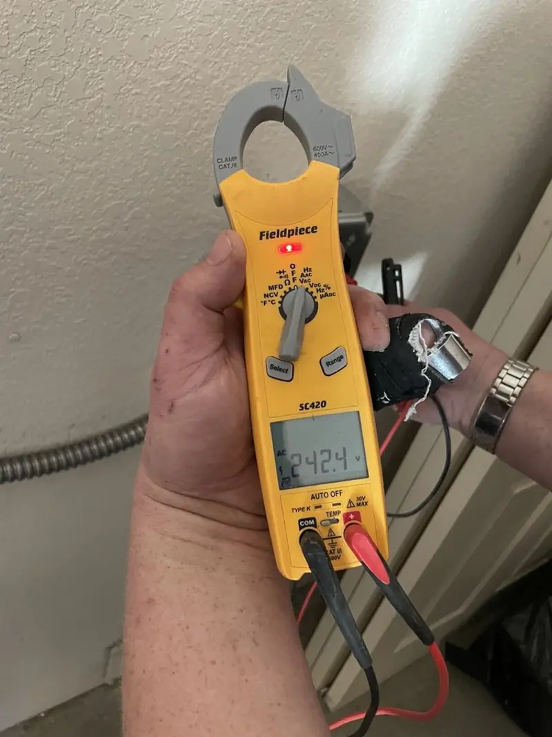 Voltage testing with clamp meter during Whole House Surge Protector in Fredon
